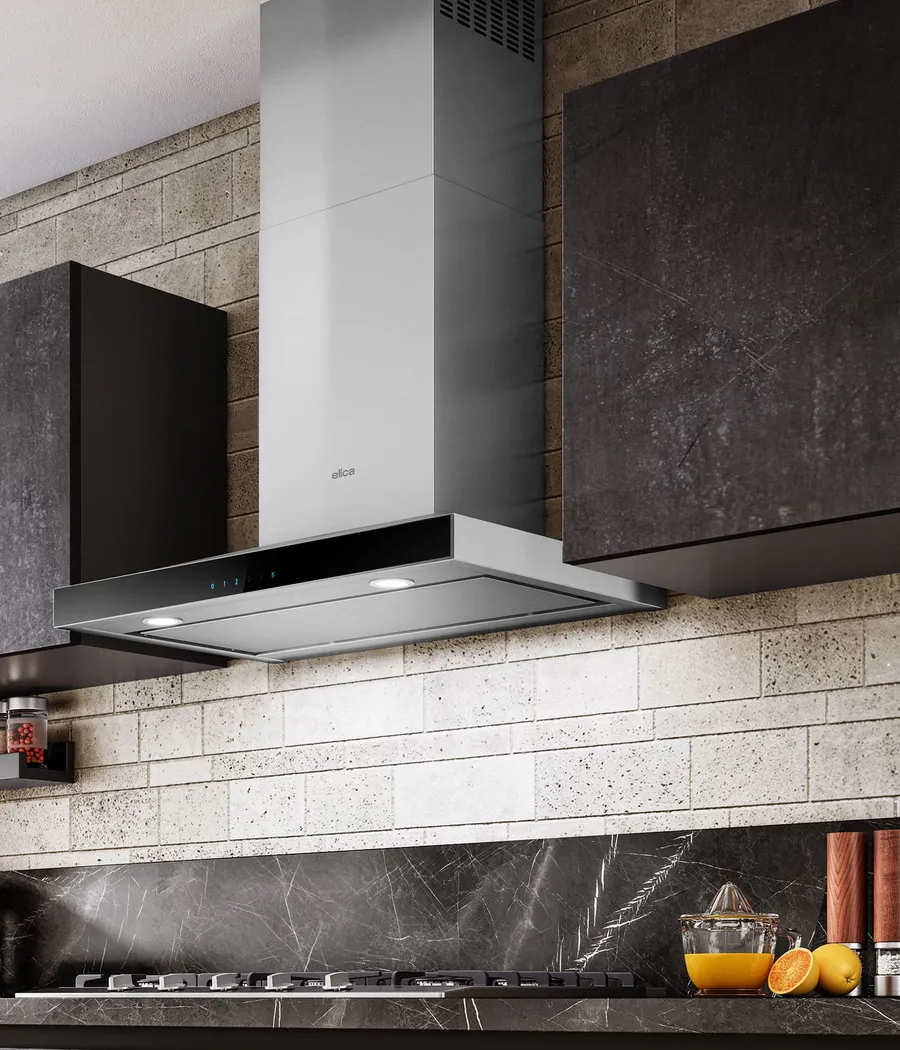Wall-mounted Elica range hood with a stainless chimney above a kitchen worktop