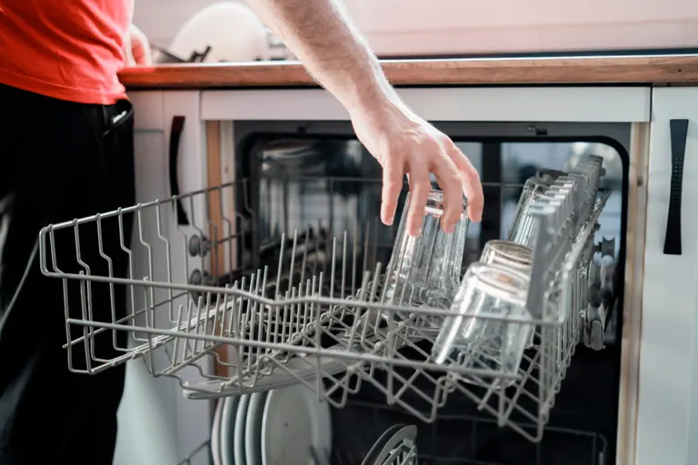 Loading glasses upside down in the top rack of a dishwasher