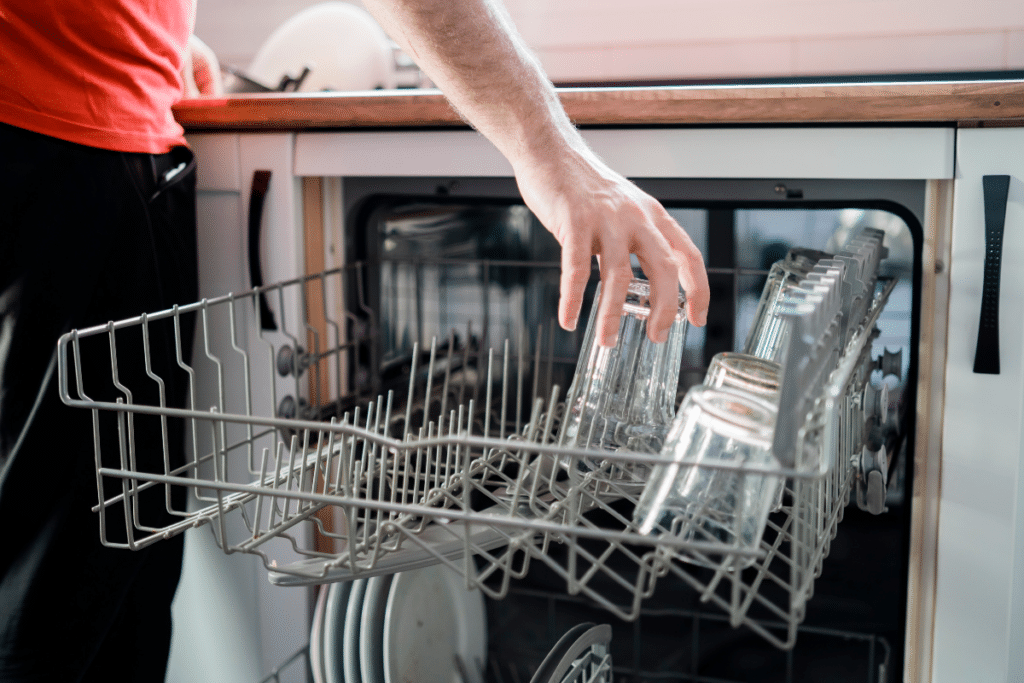 Loading glasses upside down in the top rack of a dishwasher